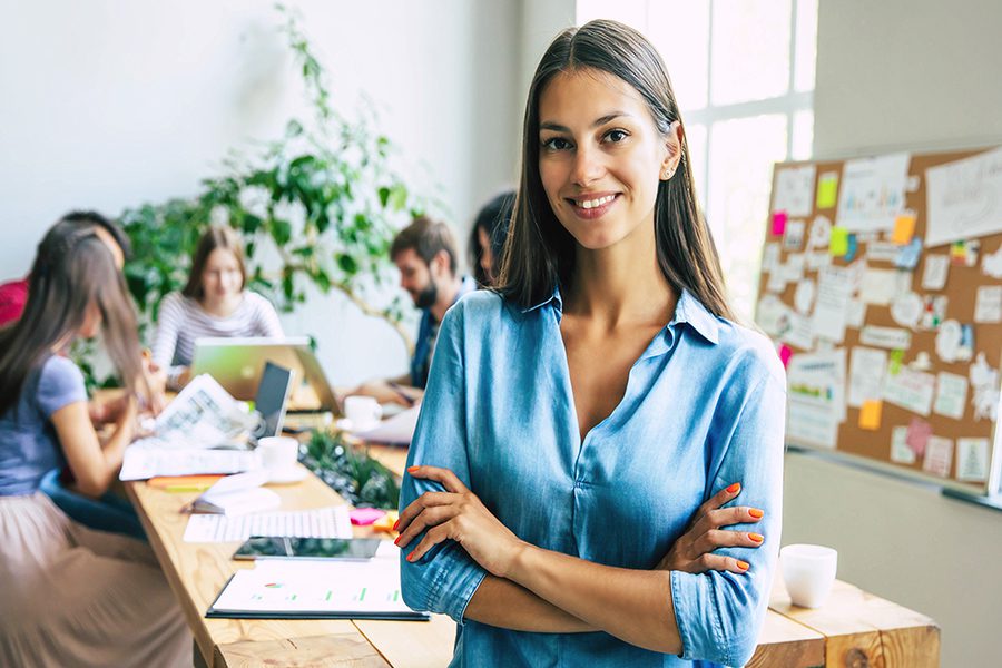 Business Start-up Services - $550 - Modern Business Woman Smiling at the Camera With Start-up Business Team